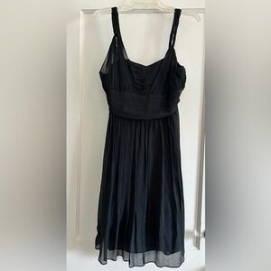 Black silk dress with twist-rope shoulder straps, pleated bodice